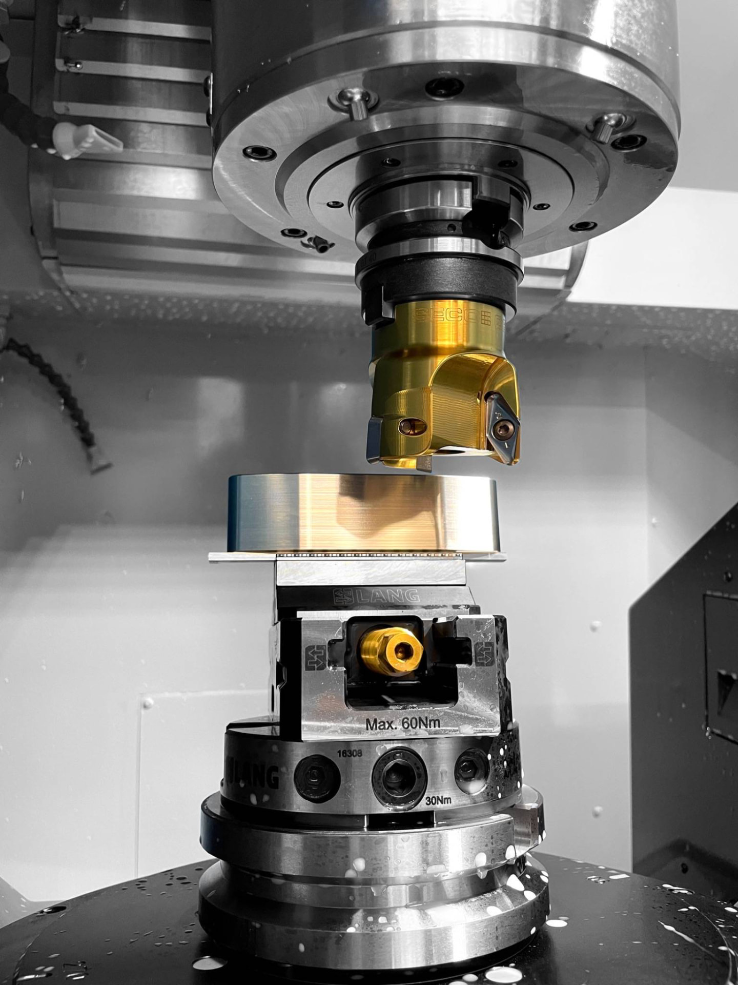 Close-up of the milling tool and spindle machining a putter head blank