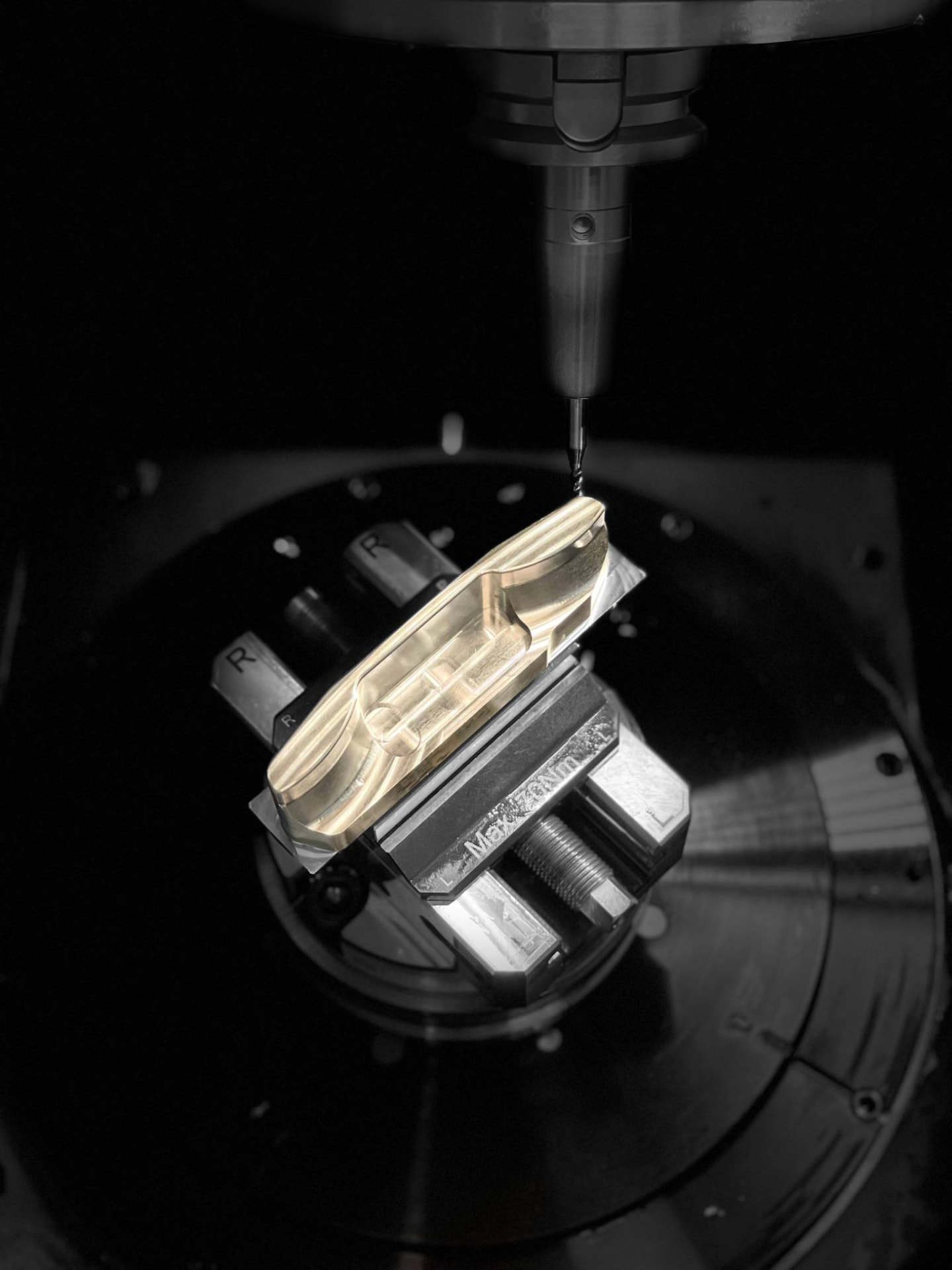 Putter head being milled from solid billet under the CNC spindle