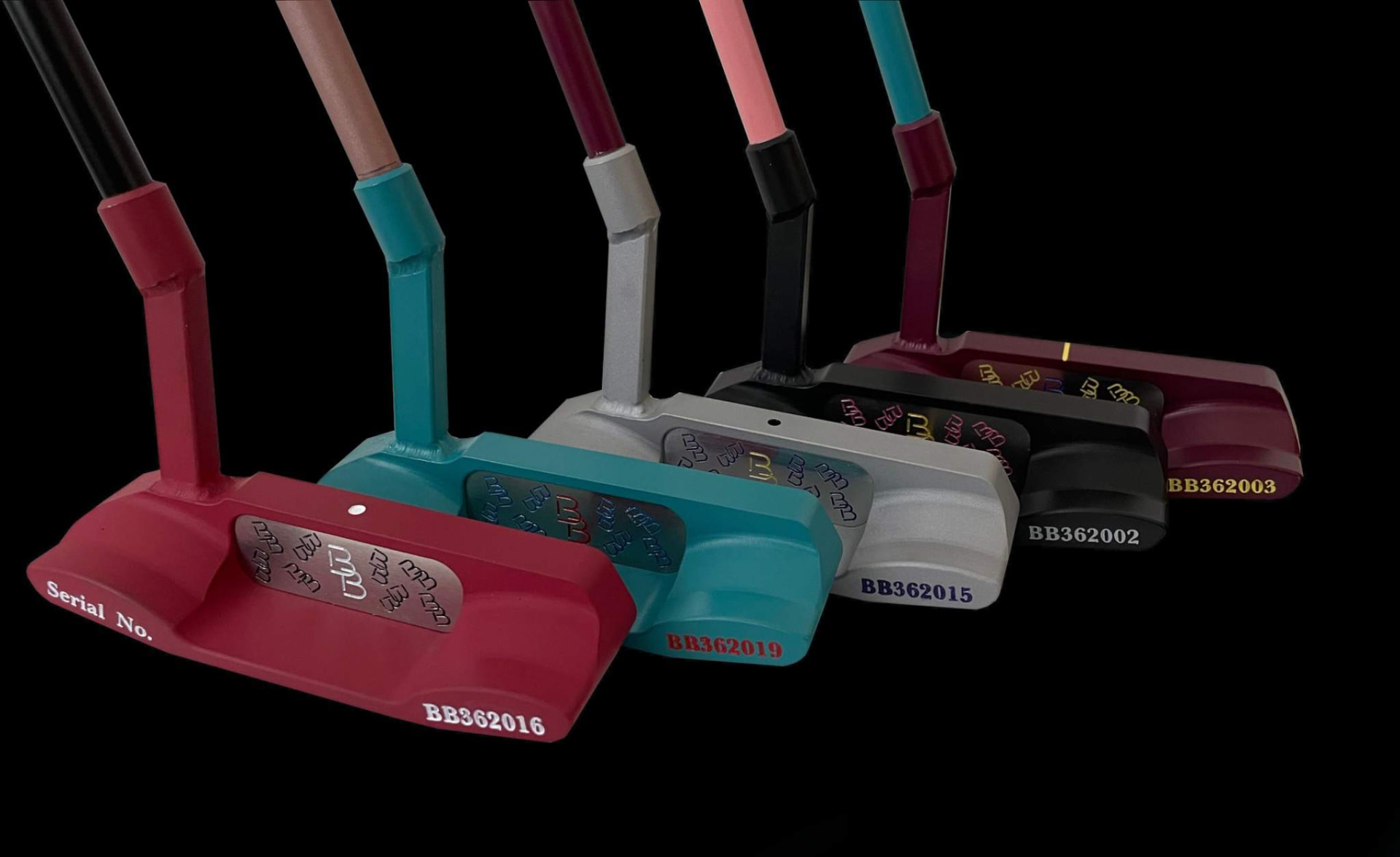 Close-up of engraved serial numbers on putter backs