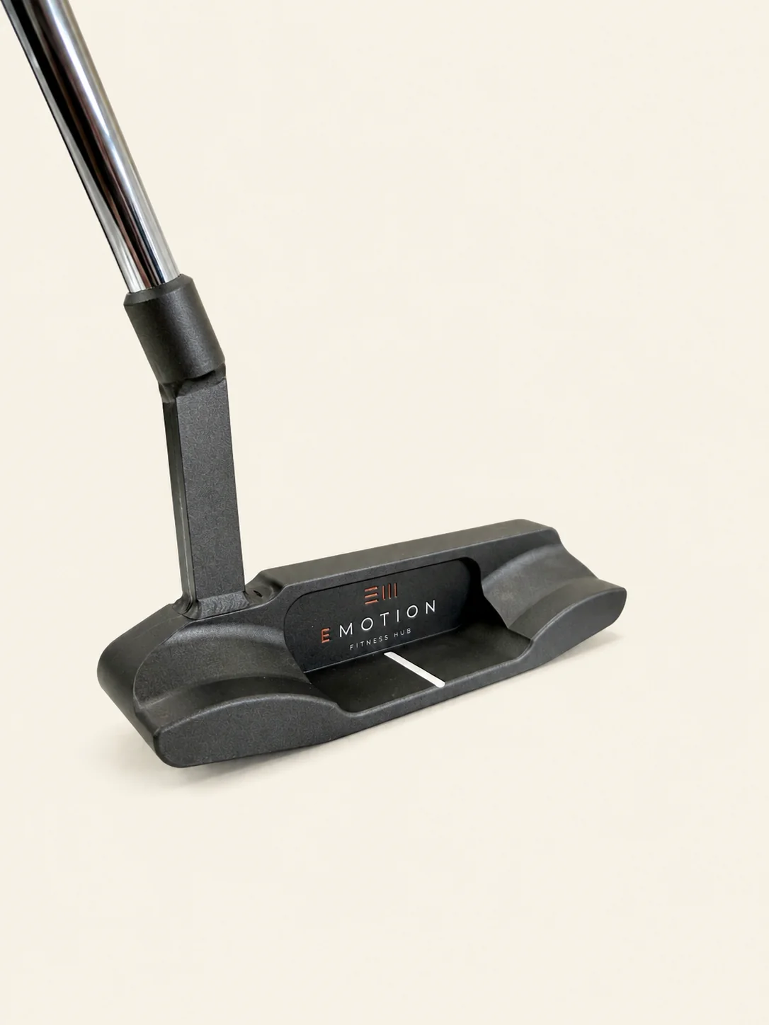 Black E-Motion Fitness Hub mallet putter shown at an angle on a cream background