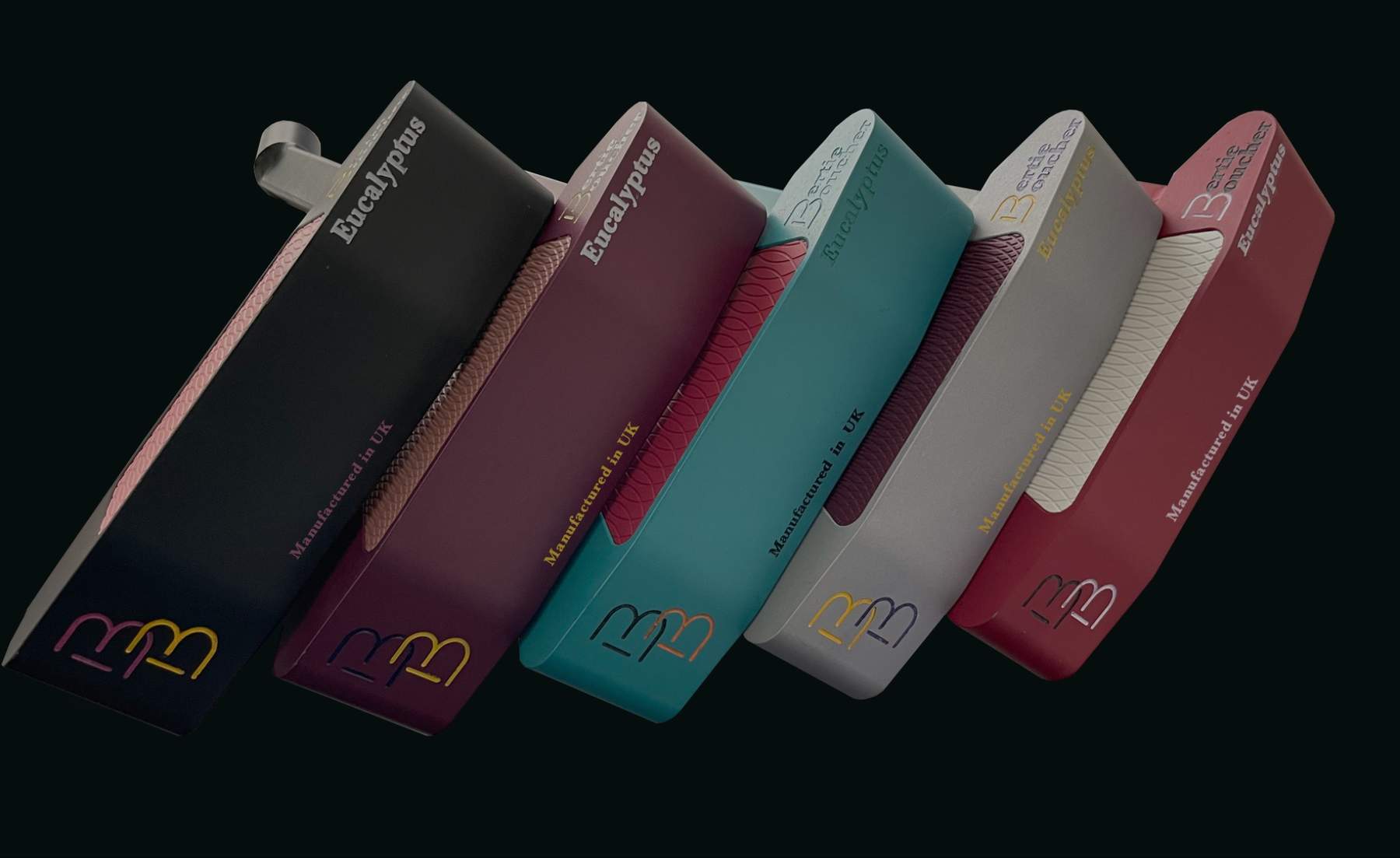 Five Eucalyptus putters lined up showing black, plum, teal, silver and red colourways