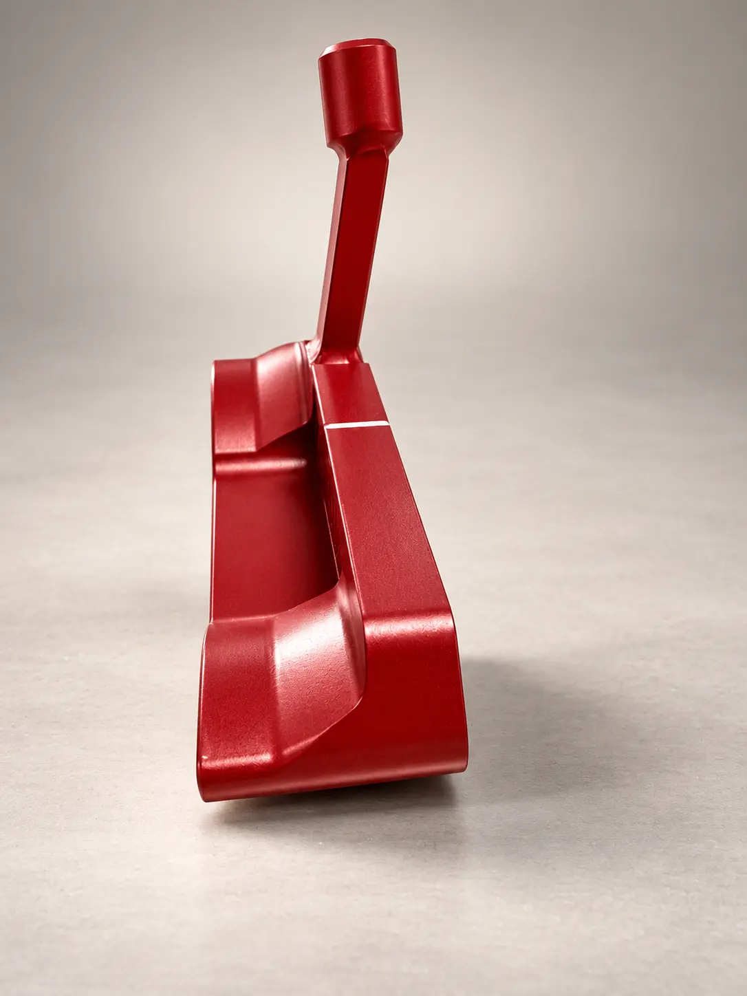 Red bespoke putter viewed from behind with a white alignment line